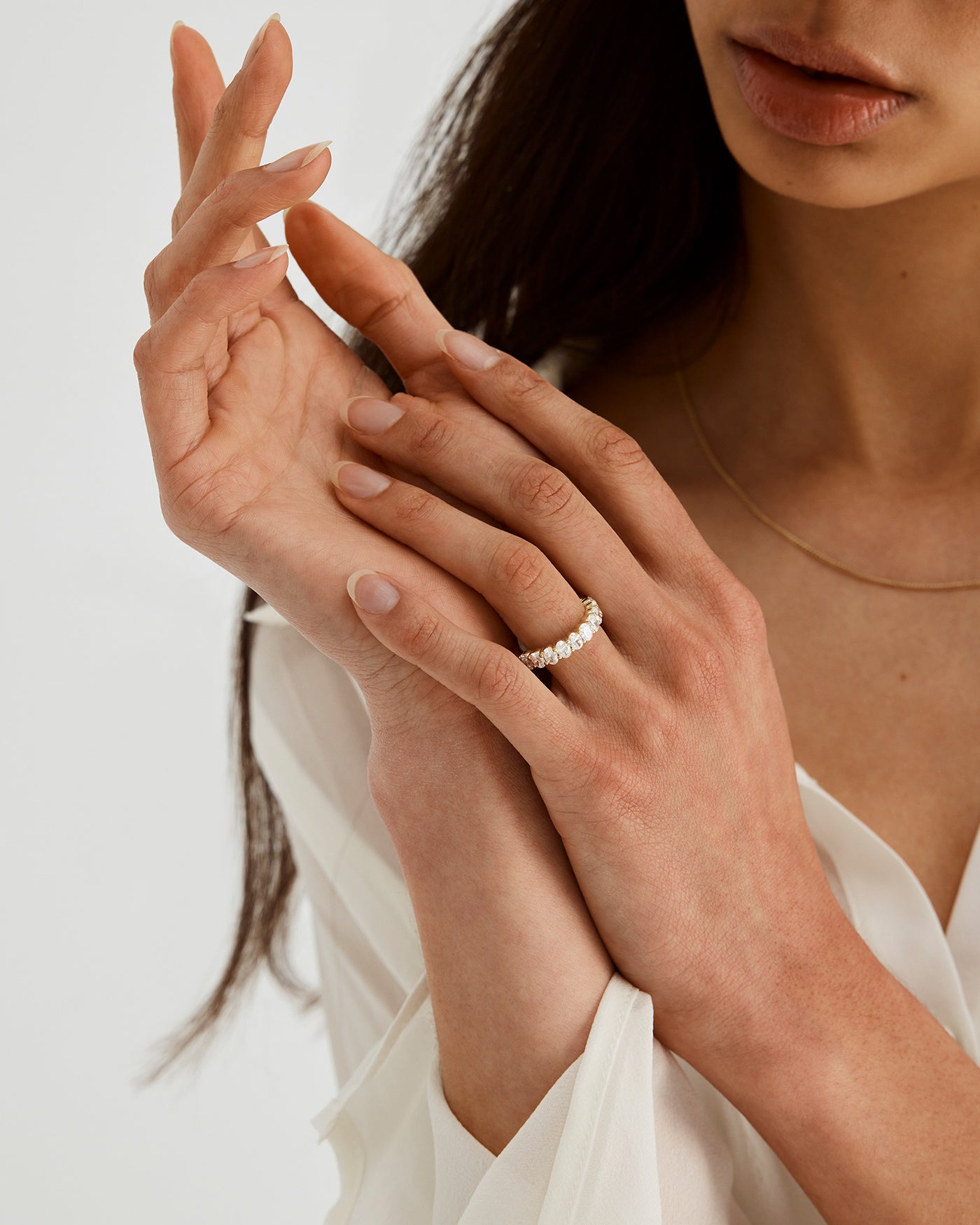 Woman wearing the Myra Engagement Ring with 11 white laboratory grown diamonds