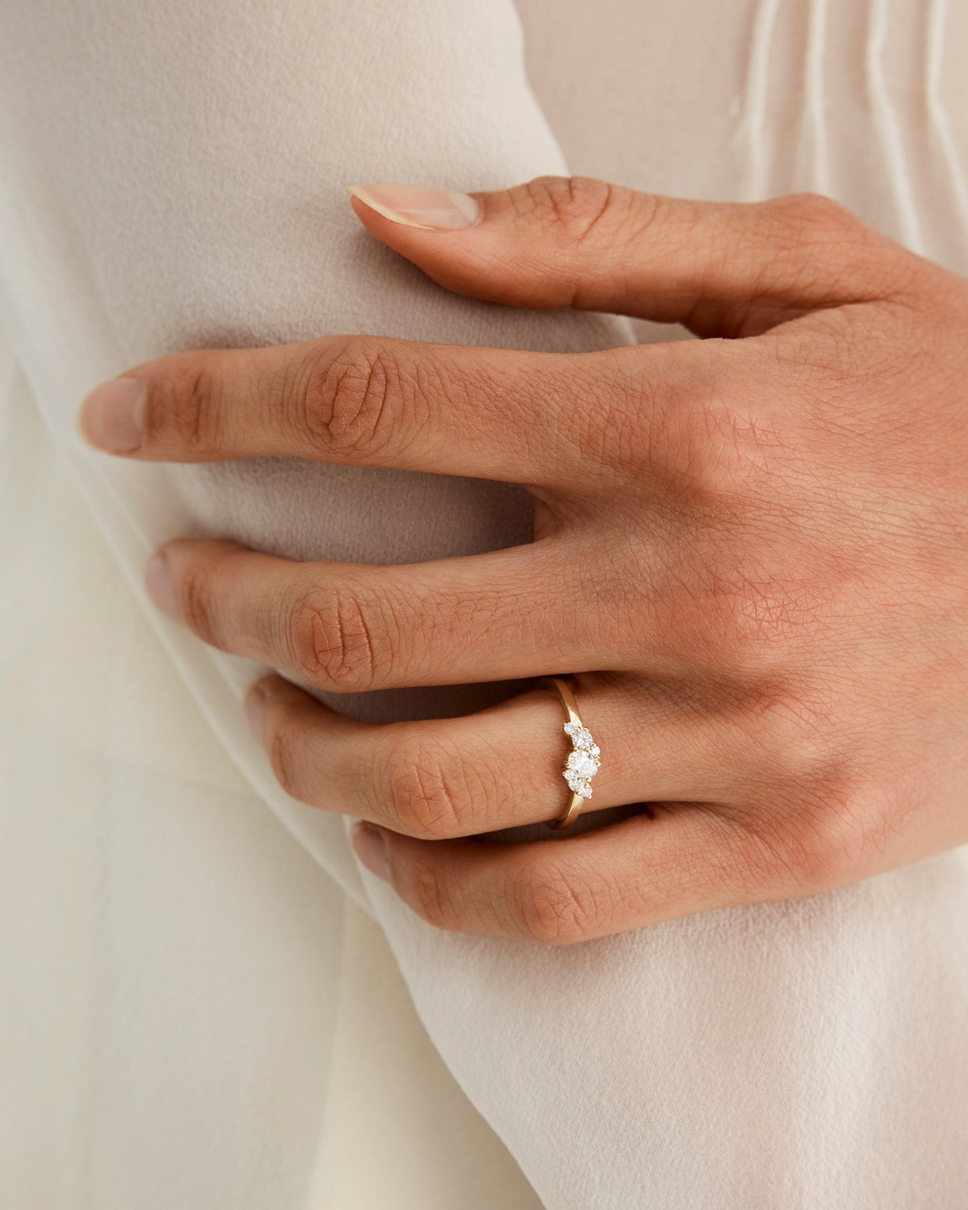 image of a womans hand wearing the iona cluster engagement ring