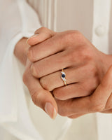 woman wearing a yellow gold  engagement ring with a cluster of diamonds