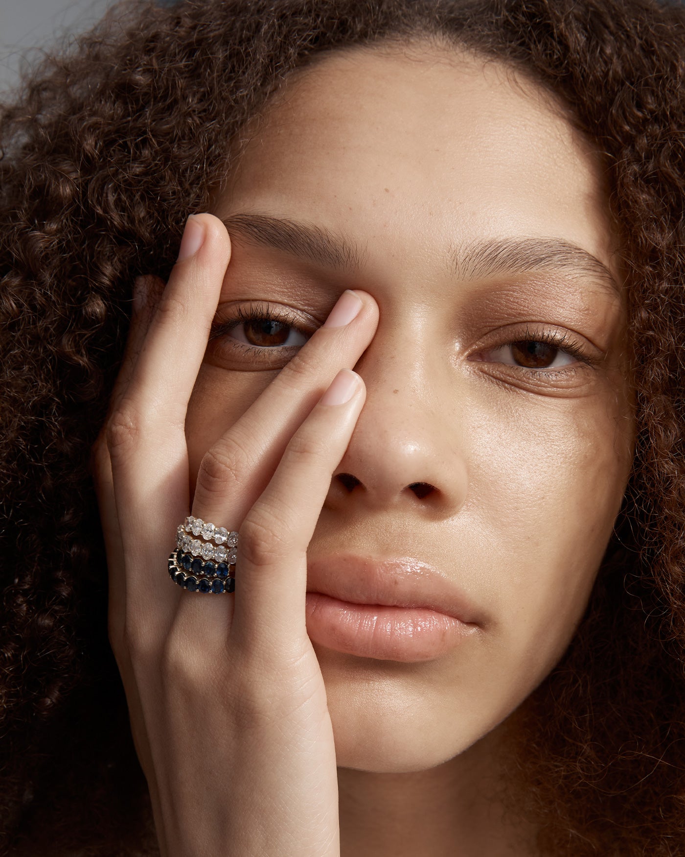 Woman wearing the macie wrap ring stacked