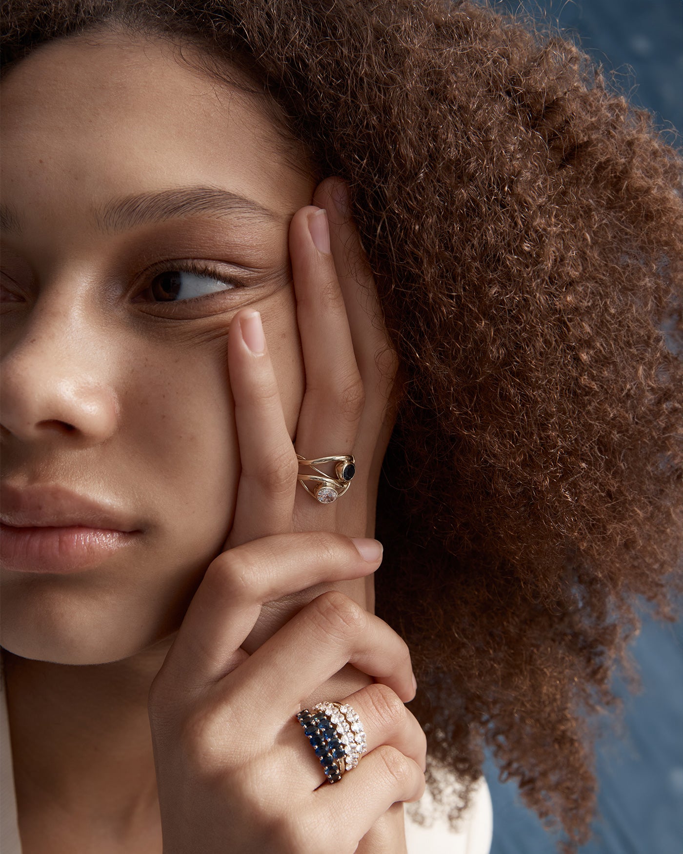 Woman wearing the myra ring stacked in diamond and sapphire 