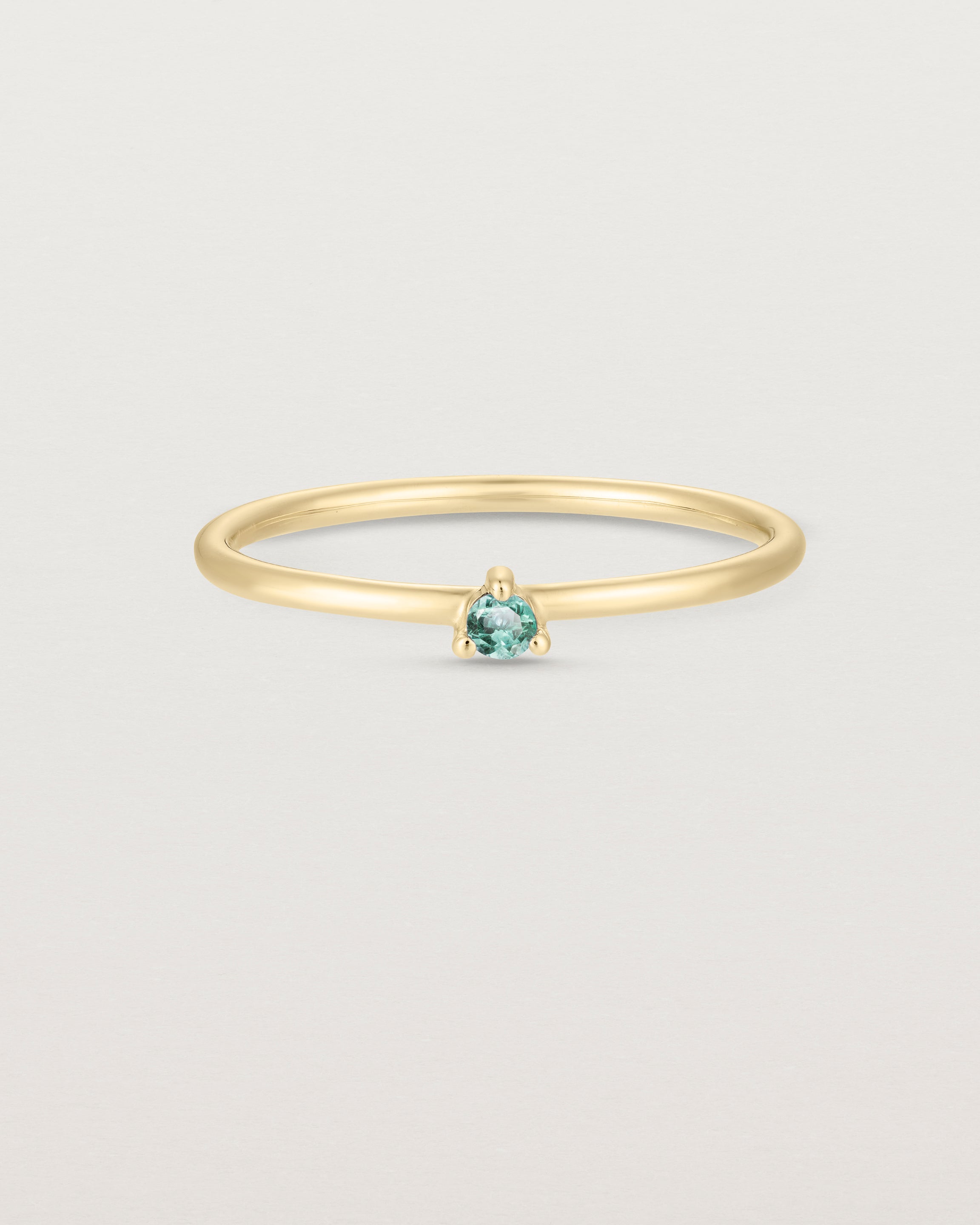 Front facing deep etched image of a yellow gold ring with an alexandrite birthstone.