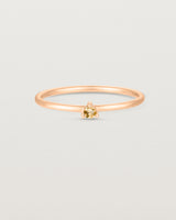 Front facing deep etched image of a rose gold ring with a citrine birthstone.