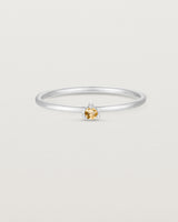 Front facing deep etched image of a white gold ring with a citrine birthstone.