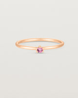 Front facing deep etched image of a rose gold ring with a pink tourmaline birthstone.