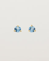 Front facing deep etched image of a pair of yellow gold earrings with an aquamarine birthstone.