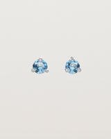 Front facing deep etched image of a pair of white gold earrings with an aquamarine birthstone.