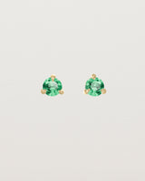 Front facing deep etched image of a pair of yellow gold earrings with an emerald birthstone.