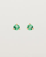 Front facing deep etched image of a pair of rose gold earrings with an emerald birthstone.