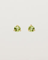 Front facing deep etched image of a pair of yellow gold earrings with a peridot birthstone.