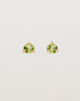 Front facing deep etched image of a pair of rose gold earrings with a peridot birthstone.