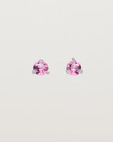 Front facing deep etched image of a pair of white gold earrings with a pink tourmaline birthstone.