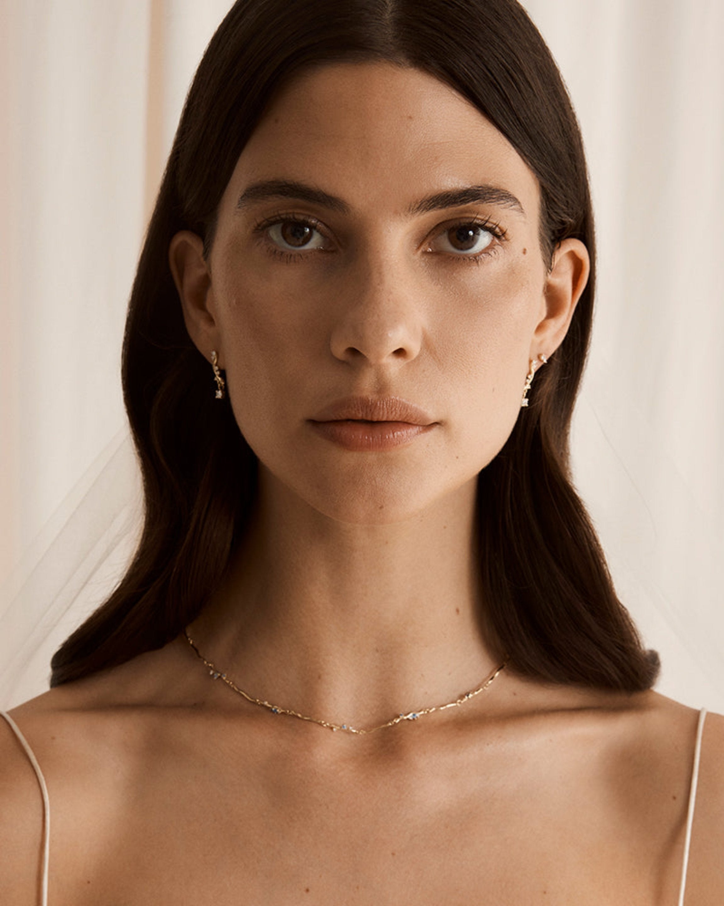 Woman wearing a white wedding dress adorned with the Demi Diamond Necklace