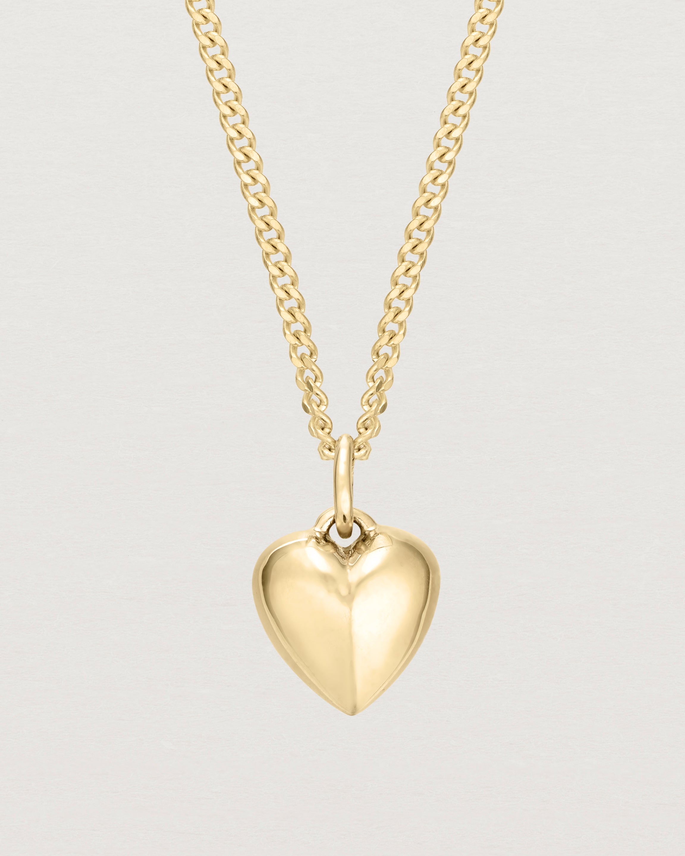 Front on image of gold heart necklace.