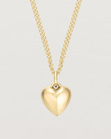 Front on image of gold heart necklace.