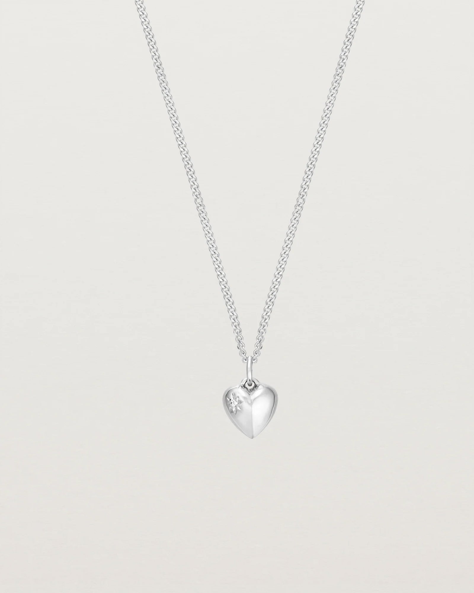 petits Ella Necklace with a White Star Set Diamond on the face of the heart pendant