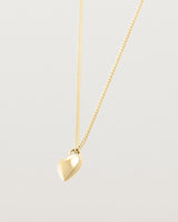 Side image of gold heart necklace.