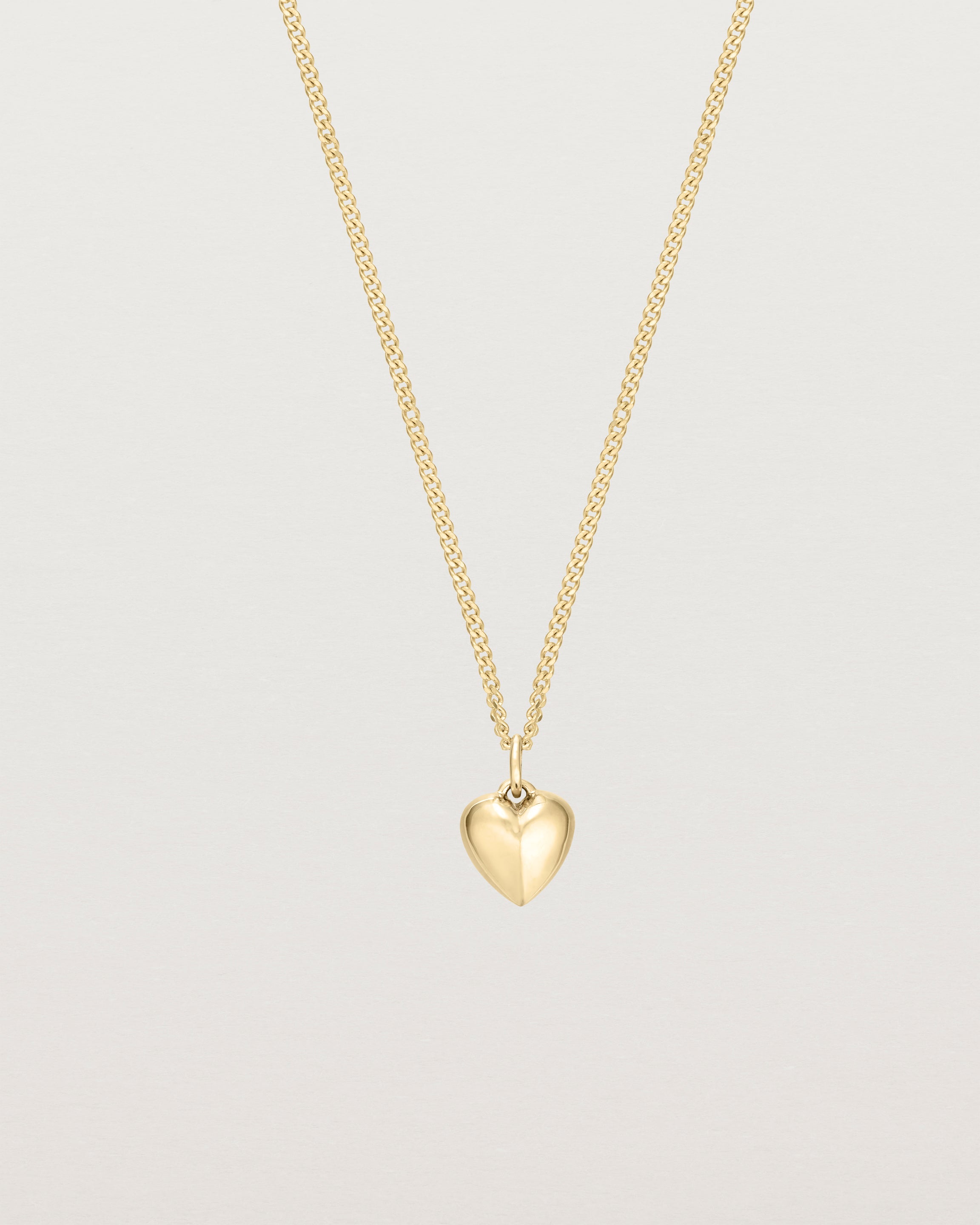 Front on image of gold heart necklace.