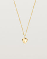 Front on image of gold heart necklace.