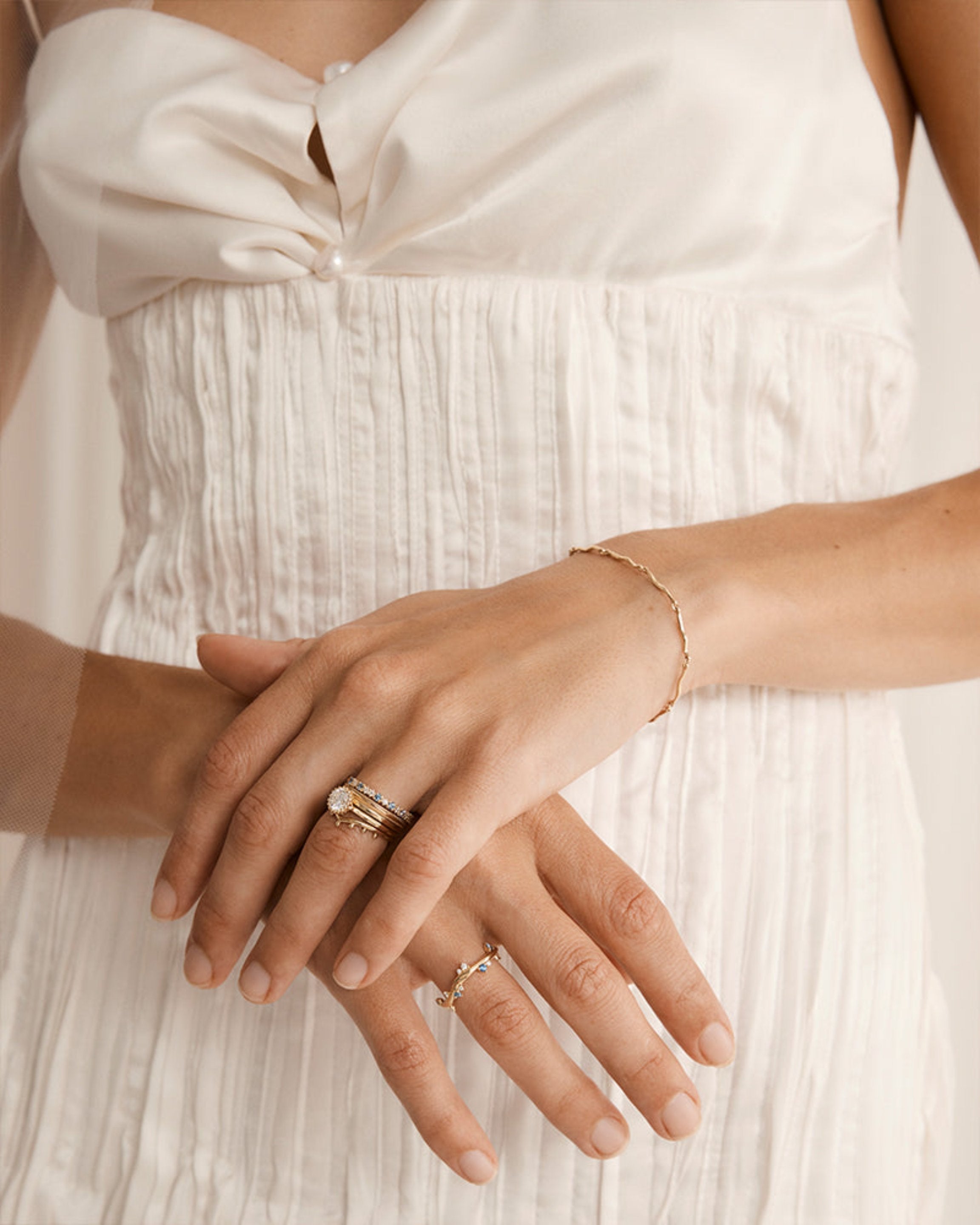 Ember sapphire ring in yellow gold being worn by a model.