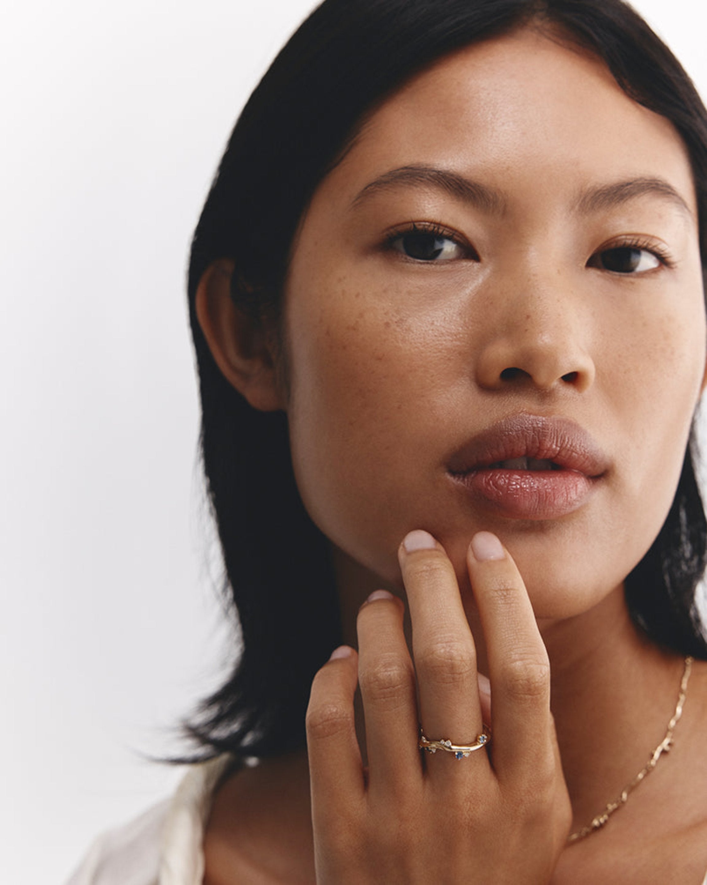 Model wears Ember Ring with Diamond & Ceylon Sapphires.