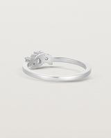 back facing deep etched image of a white gold  engagement ring with a cluster of 7 white diamonds