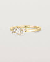 side on deep etched image of a yellow gold  engagement ring with a cluster of 7 white diamonds