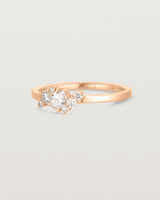 side on deep etched image of a rose gold  engagement ring with a cluster of 7 white diamonds