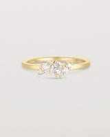 deep etched image of a yellow gold  engagement ring with a cluster of 7 white diamonds