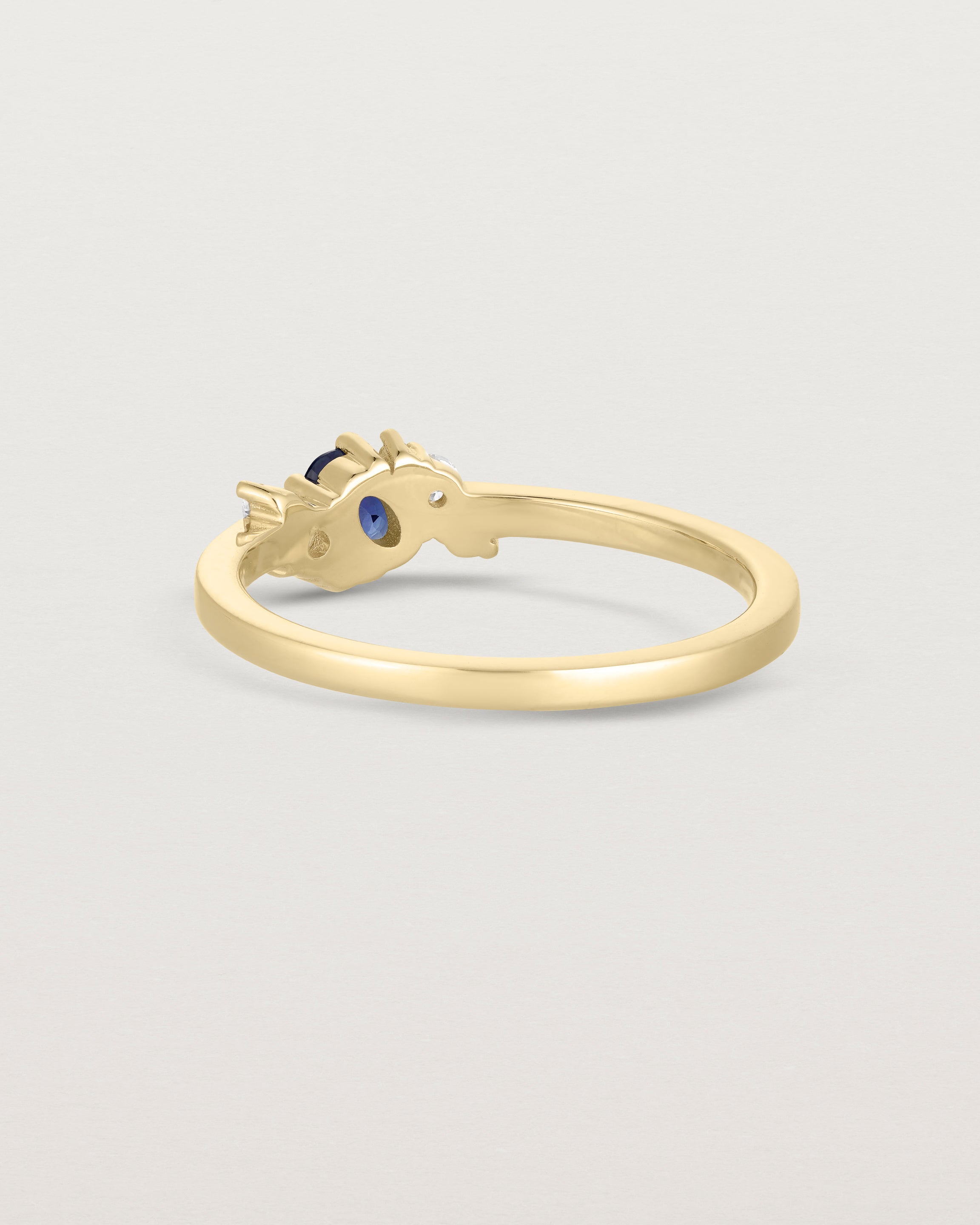 back facing etched image of a a yellow gold  engagement ring with a cluster of d