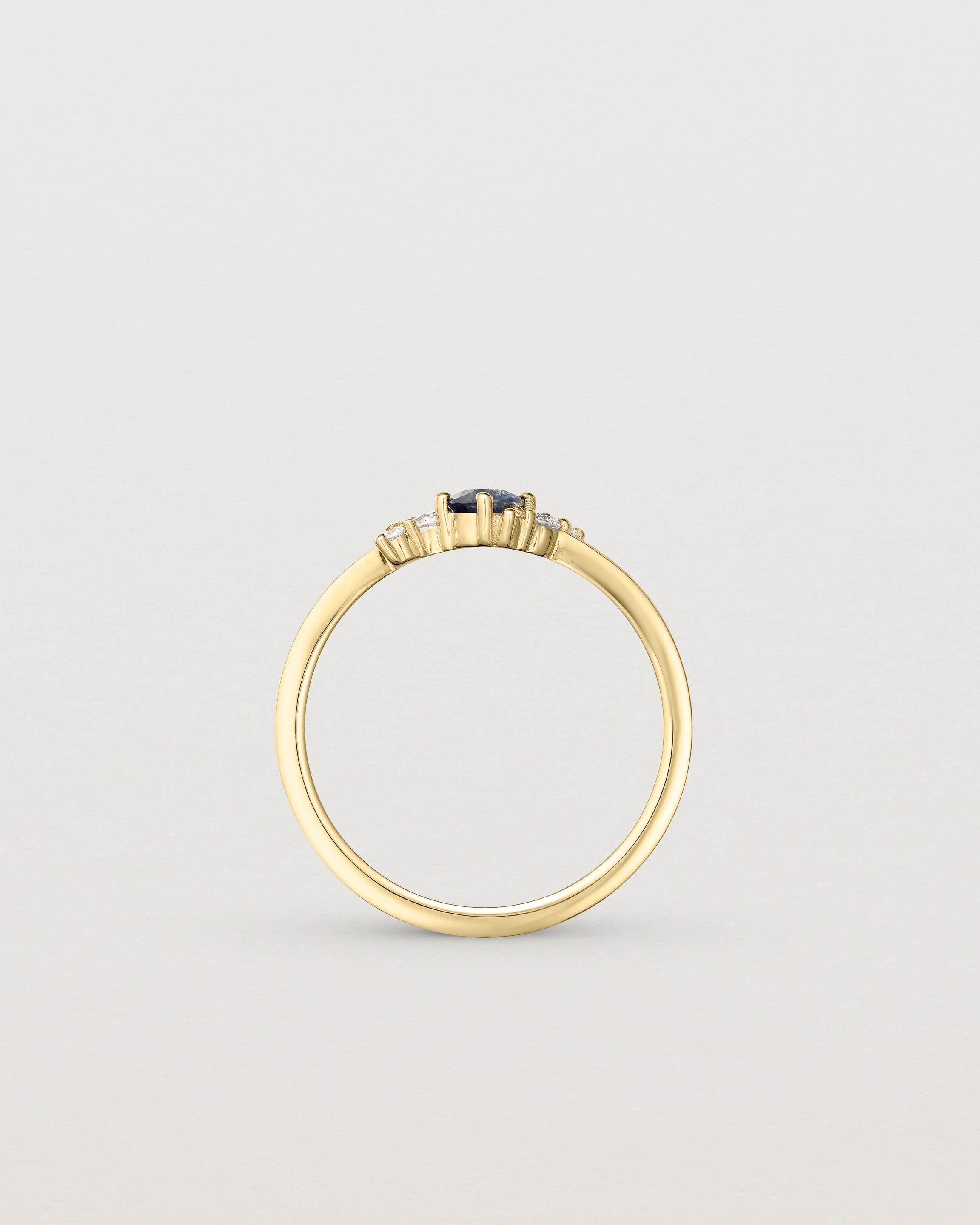 standing etched image of a yellow gold  engagement ring with a cluster of d