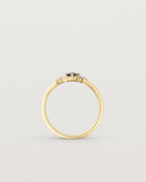 standing etched image of a yellow gold  engagement ring with a cluster of d