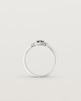 standing deep etched image of a white gold  engagement ring with a cluster of diamonds