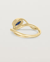 back facing deep etched image of a yellow gold  engagement ring with a oval  sapphire stone