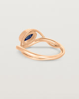 back facing deep etched image of a rose gold  engagement ring with a oval  sapphire stone