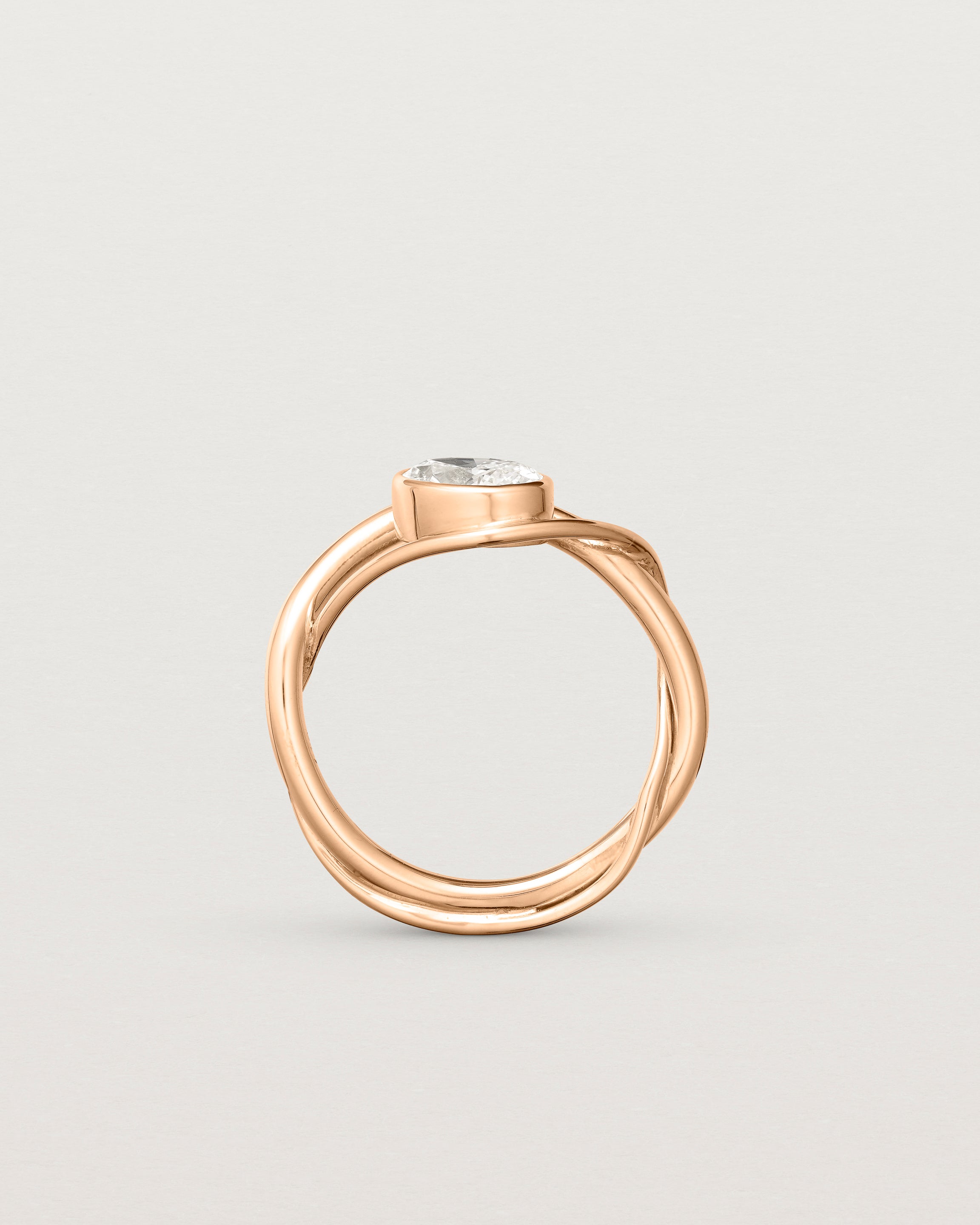 standing deep etched image of a rose gold  engagement ring with a oval  diamond stone