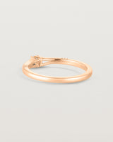 Back facing deep etched image of a rose gold engagement ring with an oval diamond