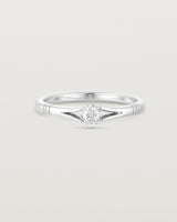 Front on deep etched image of a white gold engagement ring with an oval diamond.