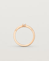 Standing deep etched image of a rose gold engagement ring with an oval diamond