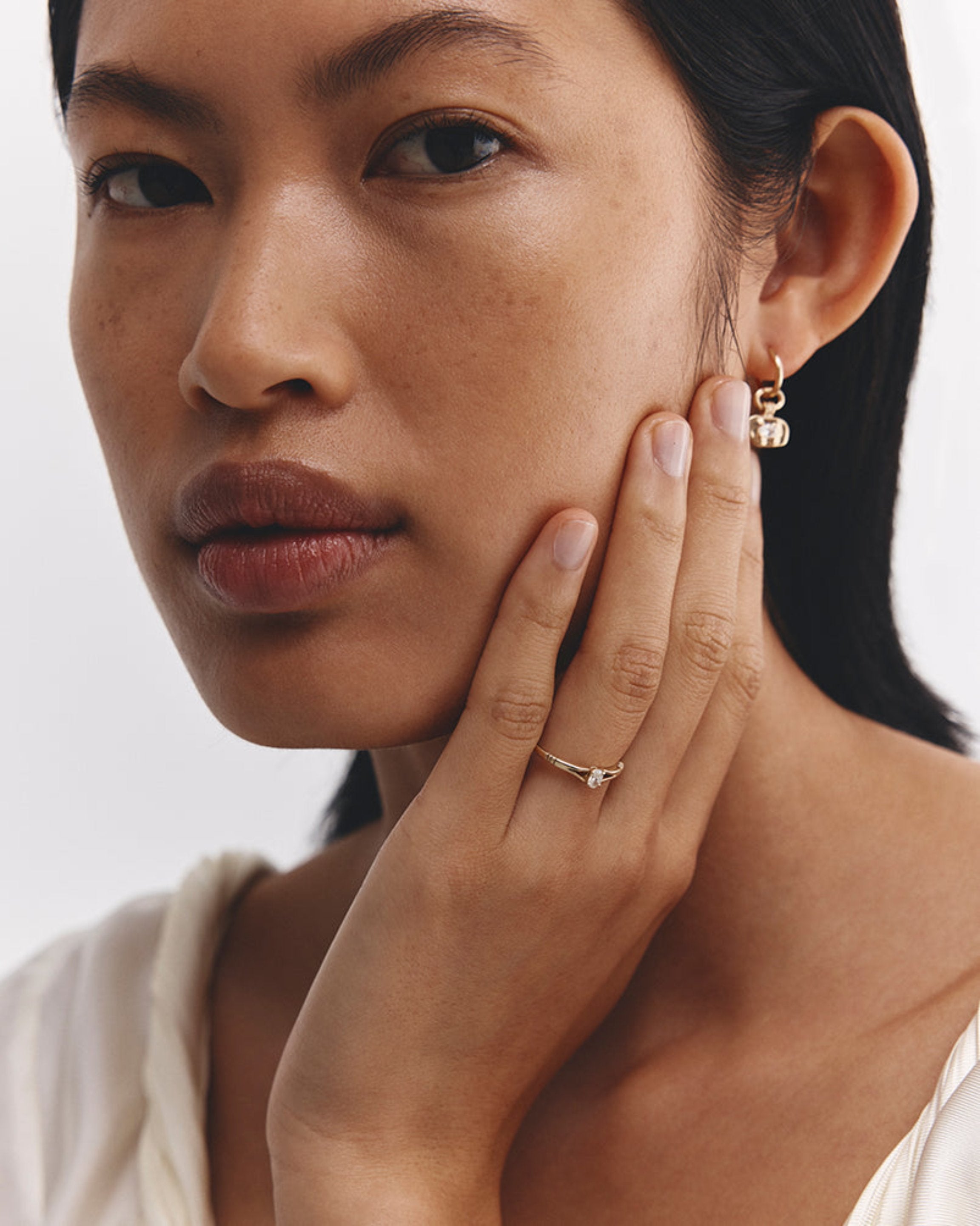 Model wears Lia Solitaire Diamond Ring in yellow gold.