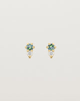 Front facing deep etched image of a pair of yellow gold earrings with alexandrite birthstones and diamonds.