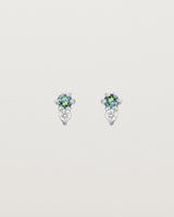 Front facing deep etched image of a pair of white gold earrings with alexandrite birthstones and diamonds.