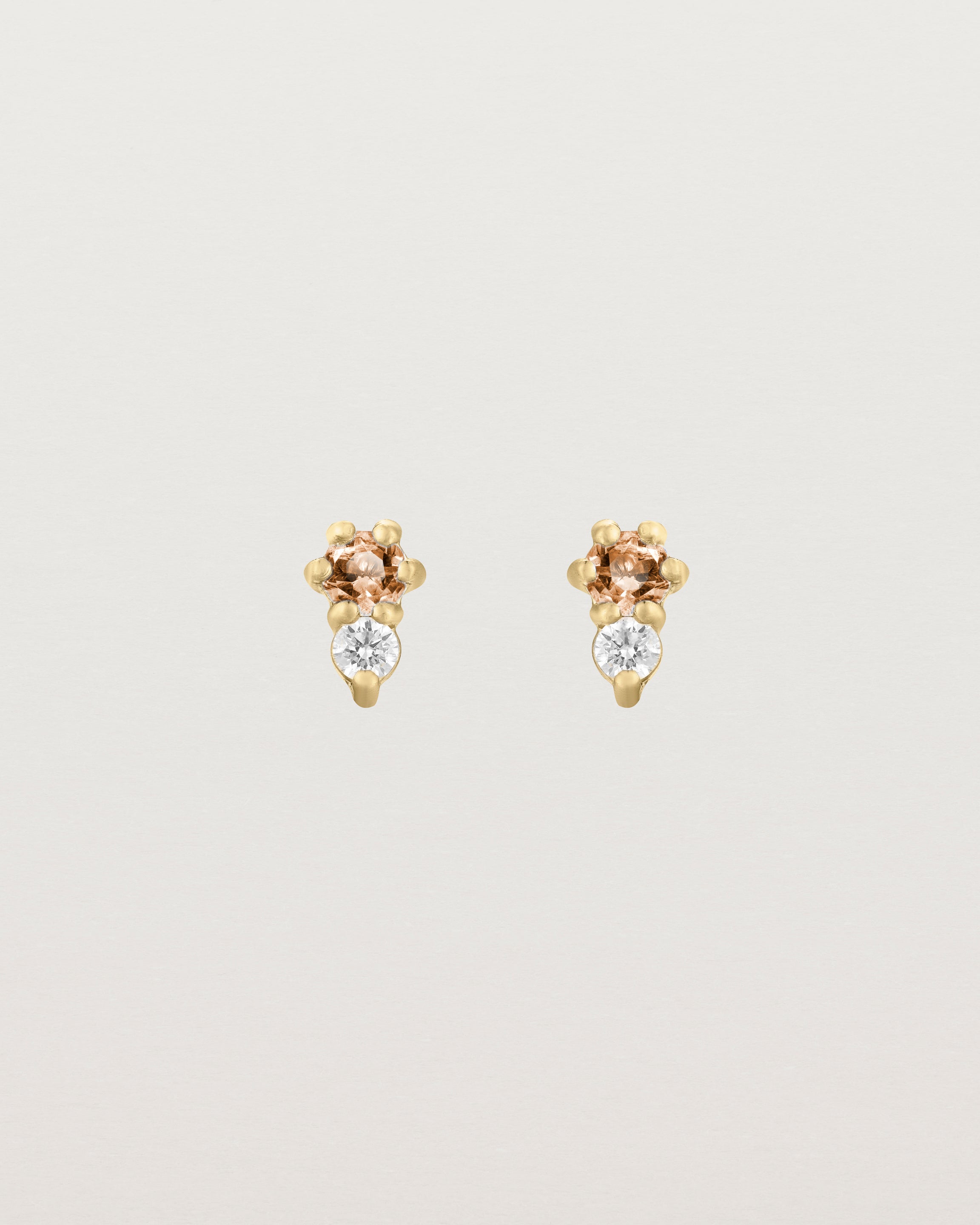 Front facing deep etched image of a pair of yellow gold earrings with citrine birthstones and diamonds.