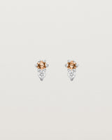 Front facing deep etched image of a pair of white gold earrings with citrine birthstones and diamonds.