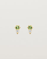 Front facing deep etched image of a pair of yellow gold earrings with peridot birthstones and diamonds.