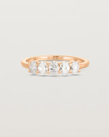 Front on deep etched image of a rose gold wrap engagement ring with five oval laboratory grown diamonds.