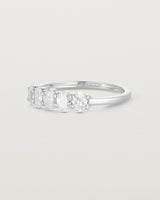 Side on deep etched image of a white gold wrap engagement ring with five oval diamonds.