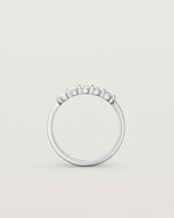 Standing deep etched image of a white gold wrap engagement ring with five oval diamonds.