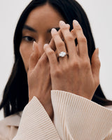 A woman wearing the Mila Emerald and Trapezoid Cut Trio ring