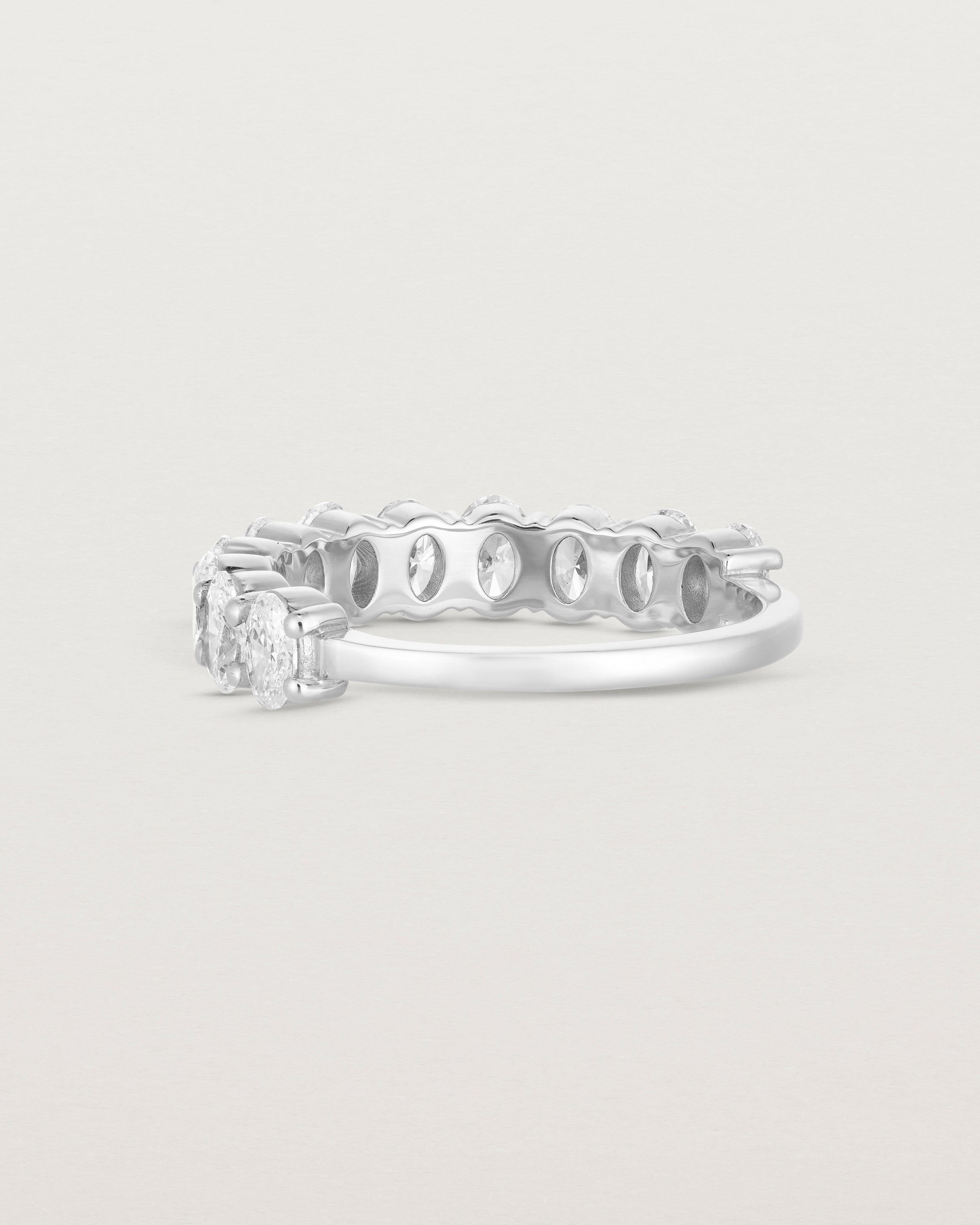 back facing deep etched image of a white gold wrap engagement ring with 11 white diamonds.